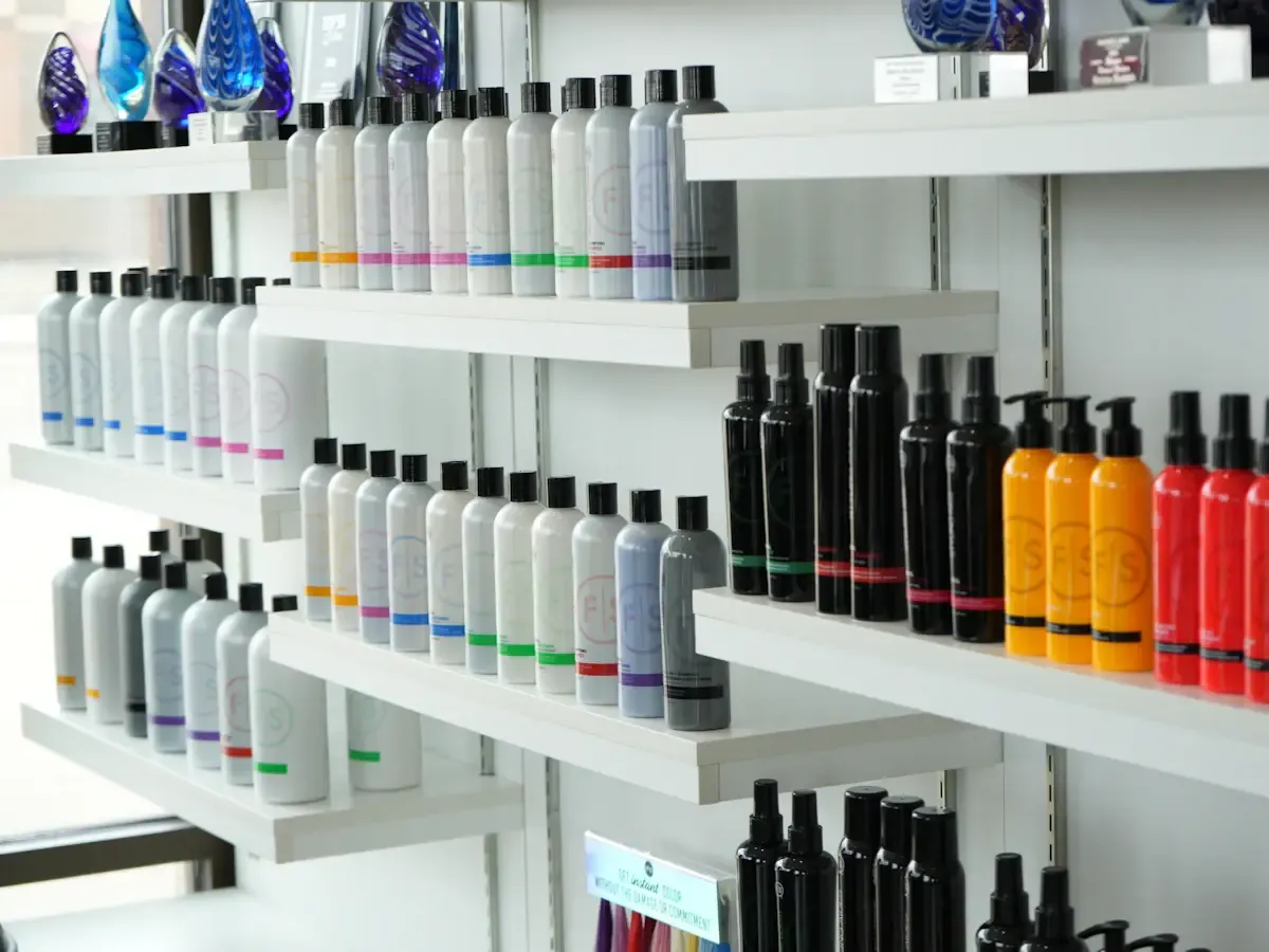 Rows of hair care bottles and aerosol cans on salon shelves, an illustrative stock photo and not the recalled products