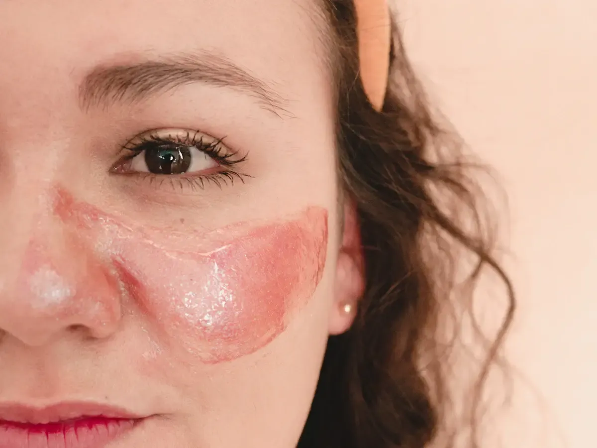 Illustrative close-up of a pink hydrogel patch applied under a woman's eye; not the actual Laneige product